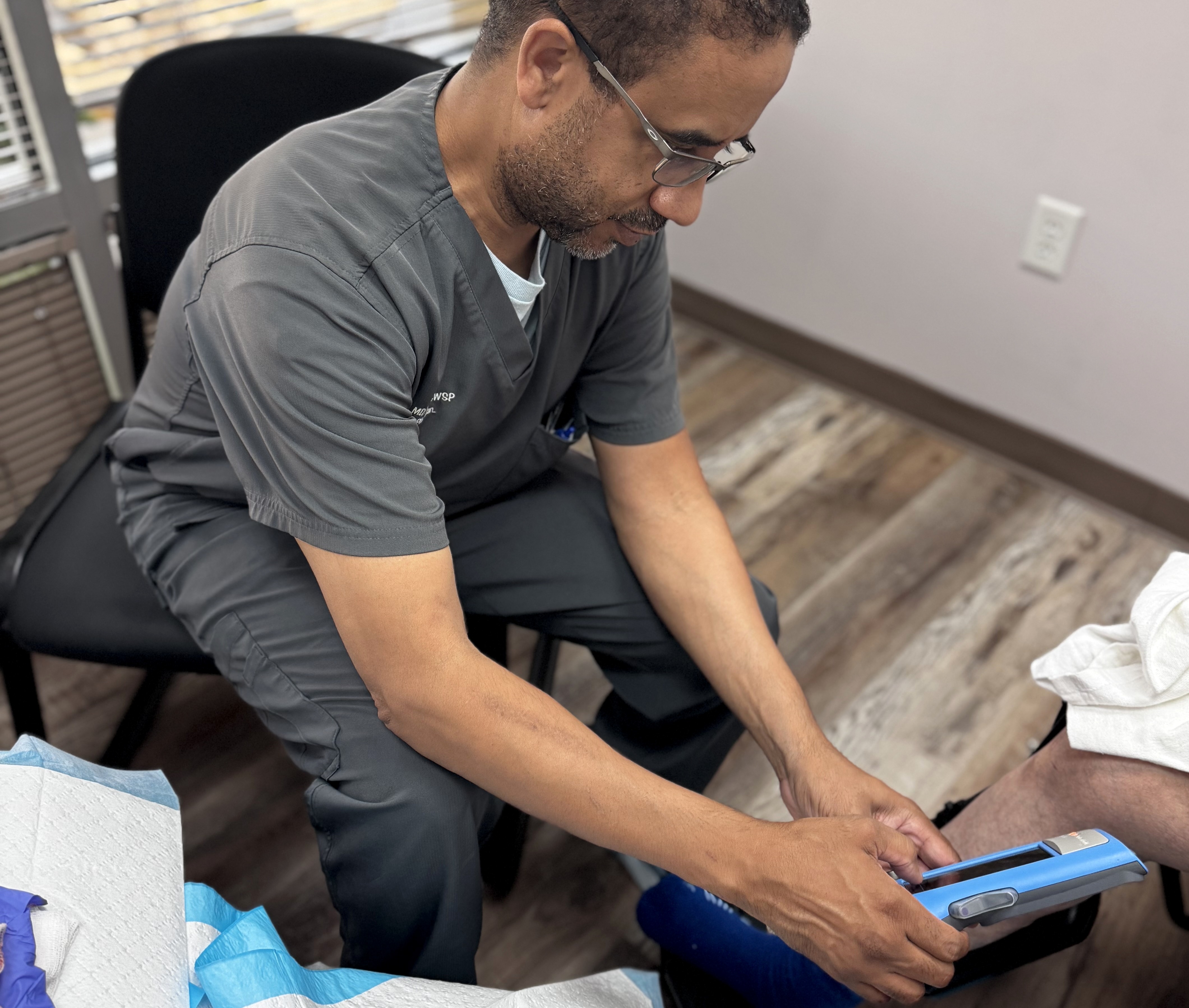 Dr. Alonso using the MolecuLight i:X fluorescence camera during a clinic visit